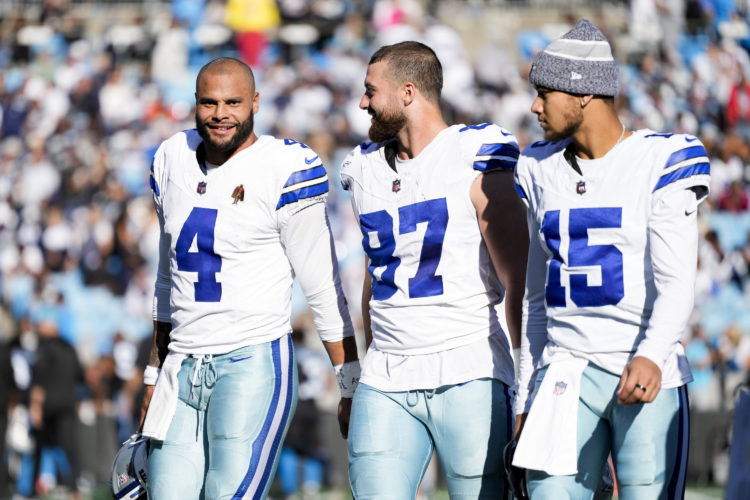 CHARLOTTE, NORTH CAROLINA - NOVEMBER 19: Dak Prescott #4, Jake Ferguson #87, and Trey Lance #15 of the Dallas Cowboys walk off the field during an ...